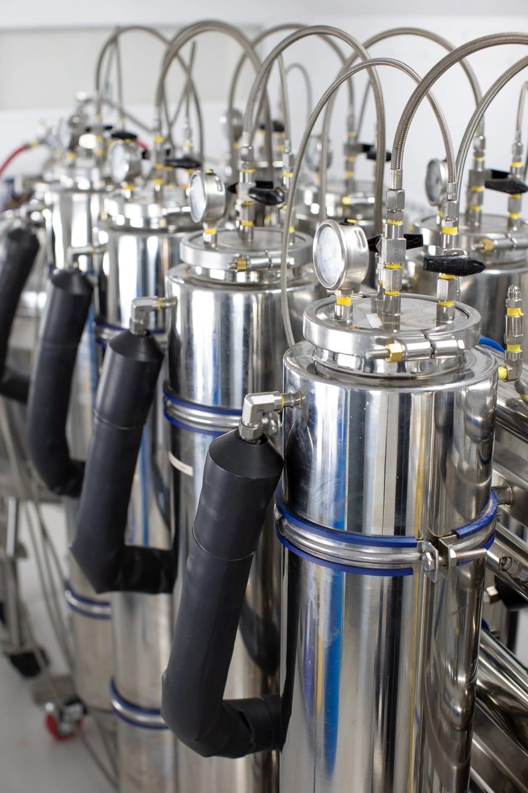 Stainless-steel extraction vessels on the CNPG production floor.
